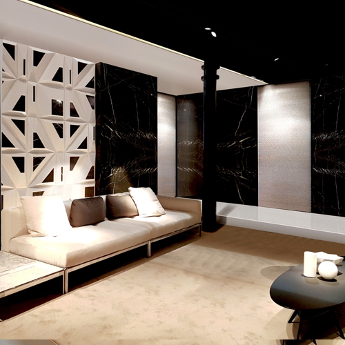lobby d'hotel con muri in marmo nero, porte in vetro con lino ed un divano lineare